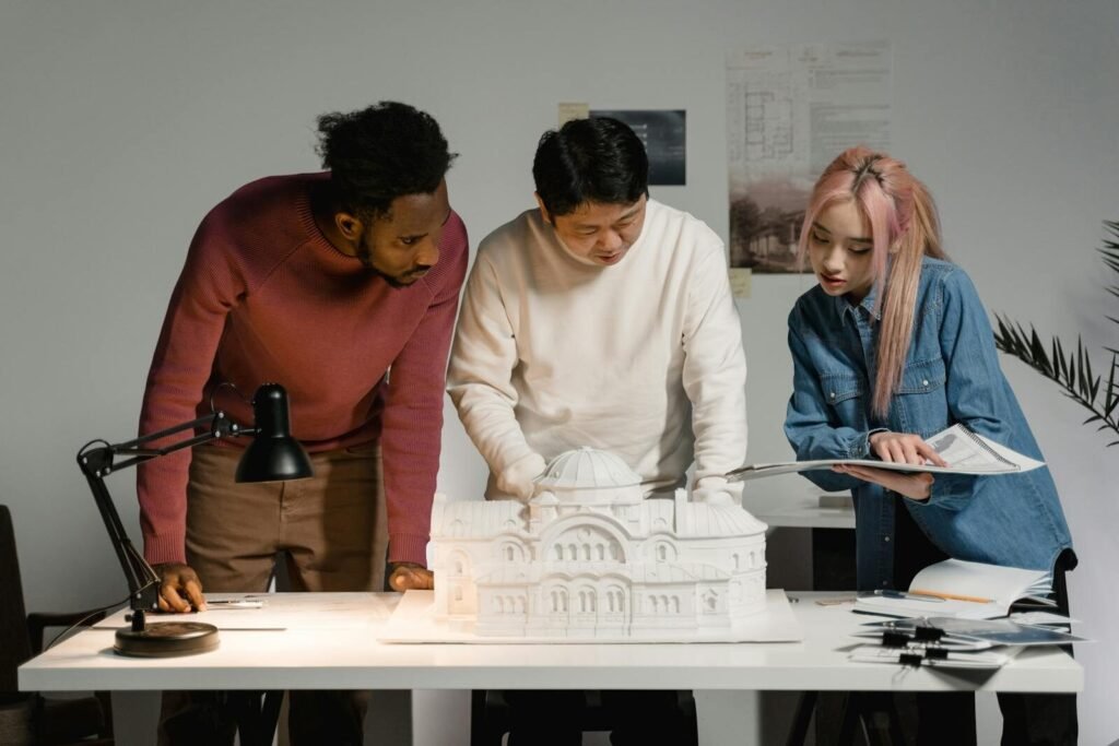 A diverse group of professionals discussing an architectural model in an office setting, emphasizing teamwork.